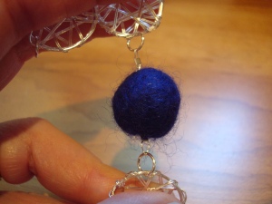 Close up of a felted bead